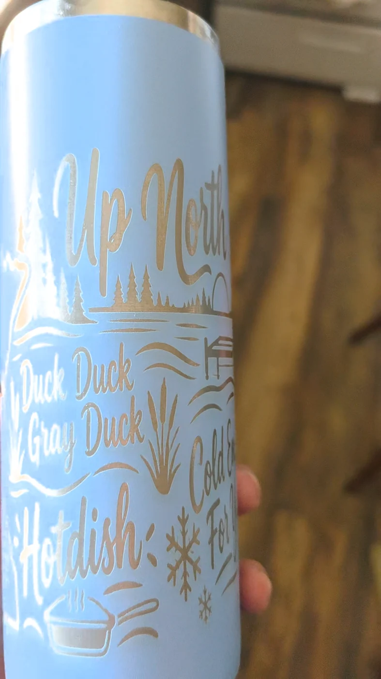 Close-up of custom laser engraved blue tumbler